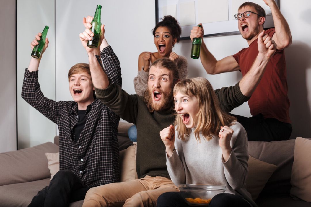 images/group-joyful-friends-sitting-sofa-happily-screaming-while-watching-tv-together-with-chips-beer-home.jpg